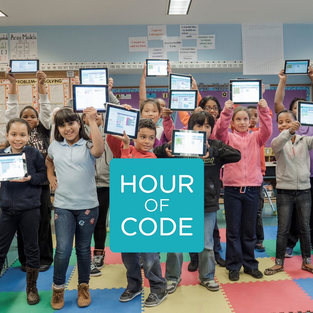 House of code students holding up ipads